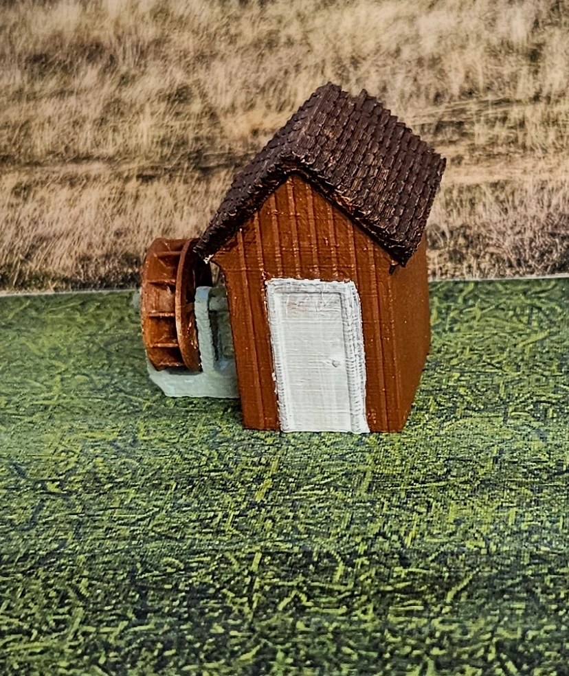 Close-up of N scale medium building and waterwheel